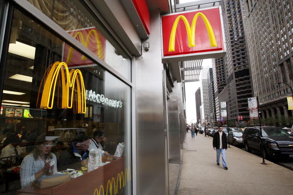 McDonalds sign over sidewalk