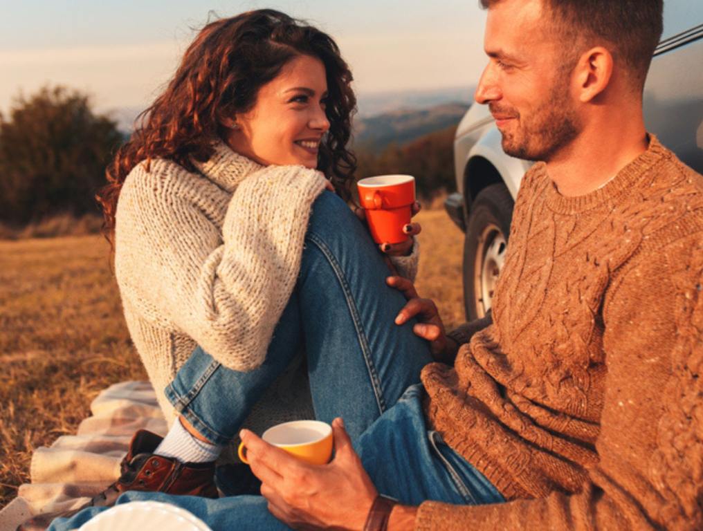 Beautiful young couple enjoying picnic time on the sunset. (North Carolina Has One of the Most Romantic Fall Getaways)