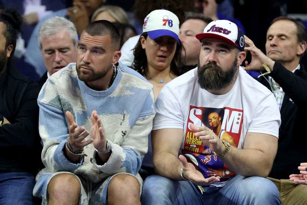 Travis and Jason Kelce sitting court-side