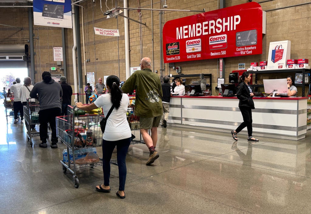 People at Costco Membership area. Costco Cracking Down On Sharing Membership Cards