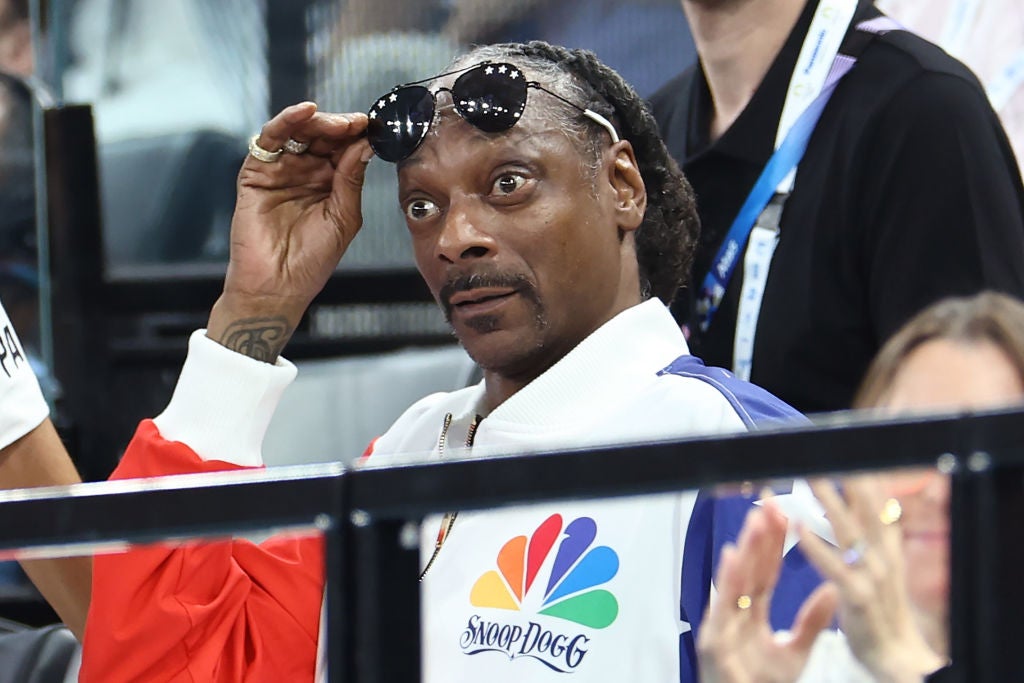 Snoop Dogg lifting up his sunglasses in disbelief while watching the 2024 Olympic Games in Paris. 5 Celebrities That Would Be Great Guests At A Dinner Party