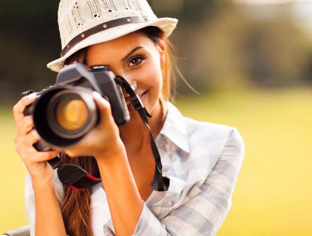 Woman taking a photo. These tips to turn your passion into a business could come in very handy.