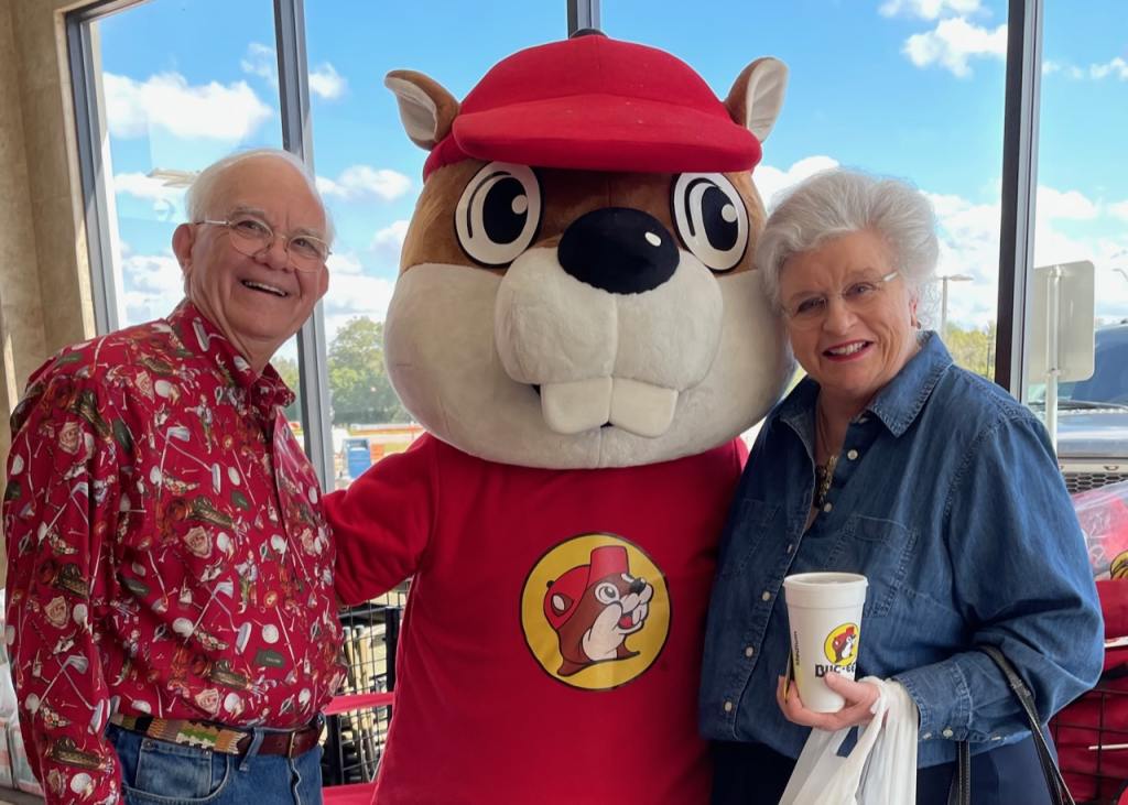 two travelers pose with the famous Buc-ee's mascot as we learn about a buc-ee's beaver mascot lawsuit filed against the florence, south carolina store