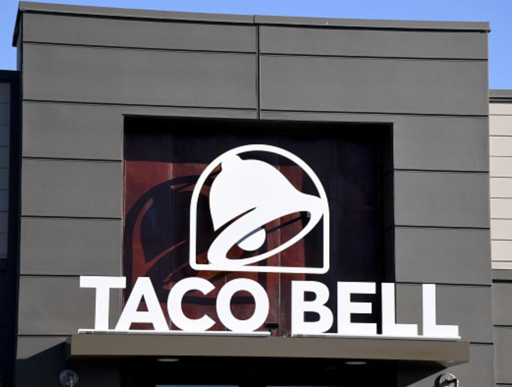 An exterior view shows a sign at a Taco Bell restaurant