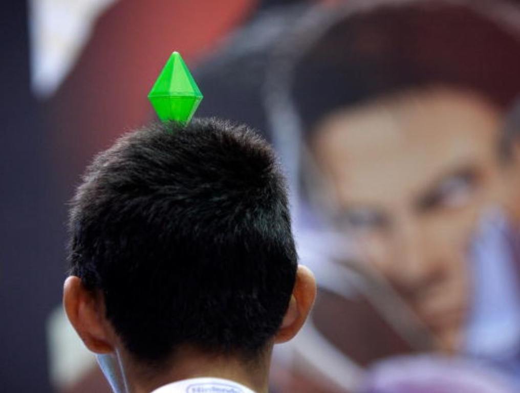 A gamer wears a gem head decoration that was handed out at the SIMS exhibit in the annual Electronic Entertainment Expo (E3) at the Los Angeles Convention Center on June 16, 2010 in Los Angeles, California.