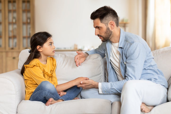 Dad Talking To Sad Preteen Daughter Supporting Her At Home