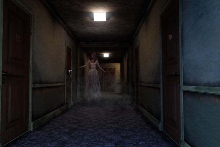 A ghostly woman in torn wedding dress floats along a dark haunted hotel hallway; 3D illustration. North Carolina Haunted Hotel