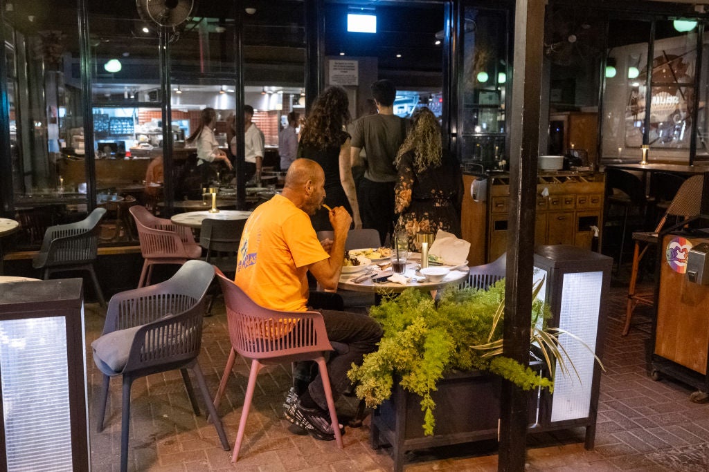 a man seated at a restaurant table as we learn about a South Carolina man eats out every day