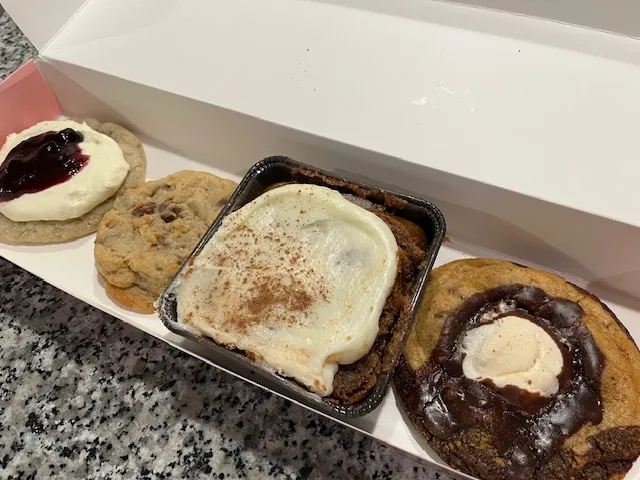 crumbl cookies in a box as we reveal this month's crumbl cookies spoilers