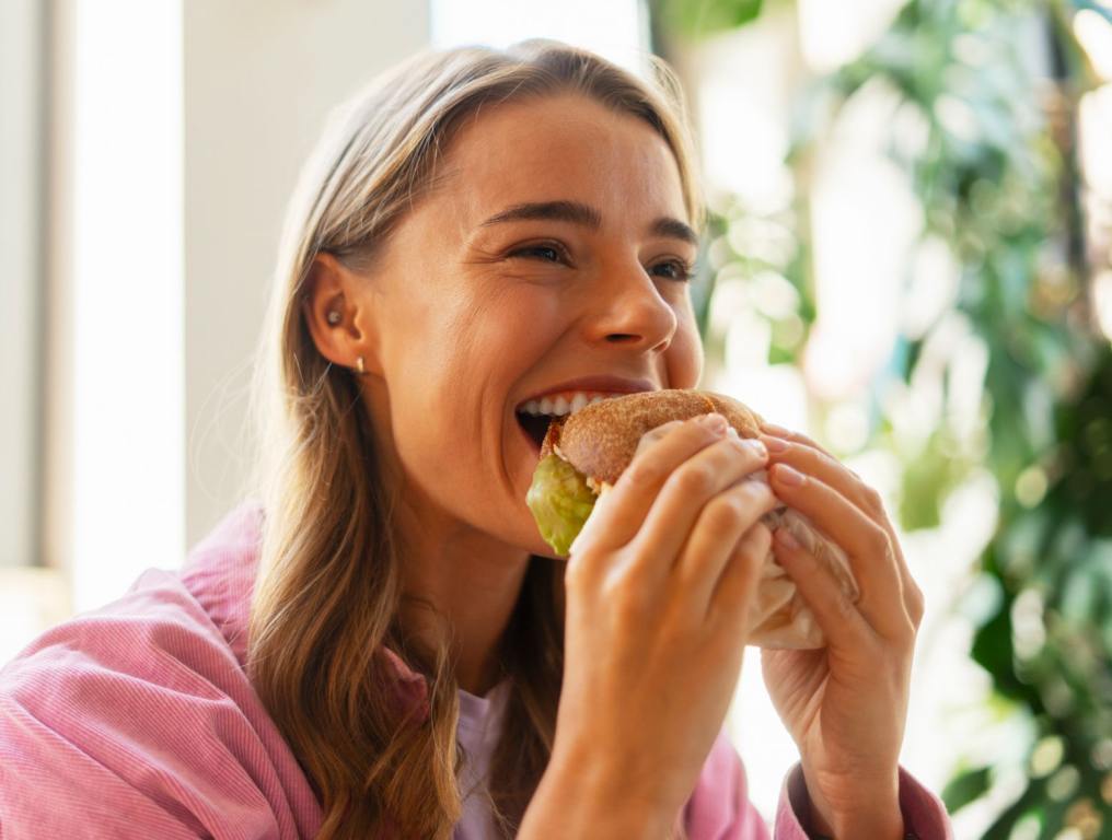 Woman eating burger. One North Carolina burger has been named among the best in America by food experts.