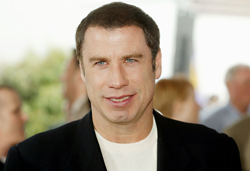 John Travolta in a white shirt with a black blazer