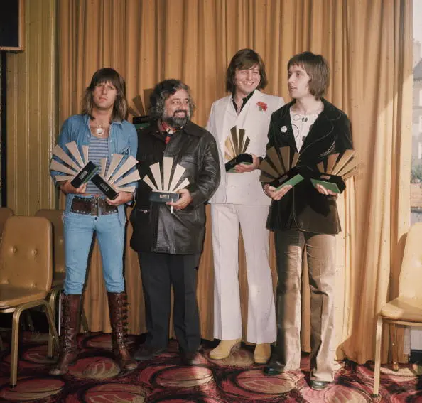 1972: Keyboardist Keith Emerson, lead singer and bassist Greg Lake and drummer Carl Palmer of the British group Emerson Lake And Palmer receive their awards at the 1972 Melody Maker Pop Poll. Readers of the weekly music paper voted ELP the World's Top Group. They are with American disc jockey and singer Wolfman Jack (1938 - 1995).